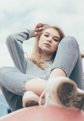 
A girl sits in a stadium, a girl of model appearance sits in a stadium