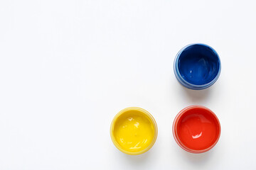 Composition with paints on white background, top view
