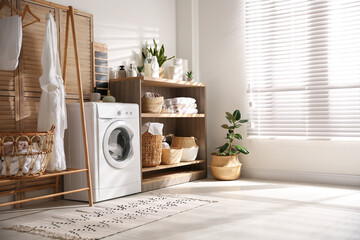 Modern washing machine and shelving unit in laundry room interior - obrazy, fototapety, plakaty