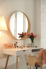 Stylish room interior with dressing table and mirror
