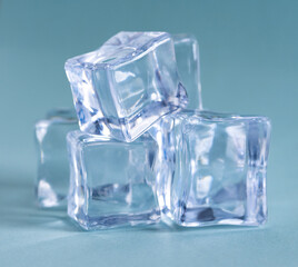 Pile of plastic ice cubes isolated on blue background