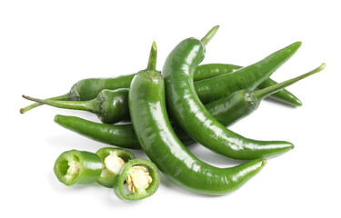 Cut and whole green hot chili peppers on white background