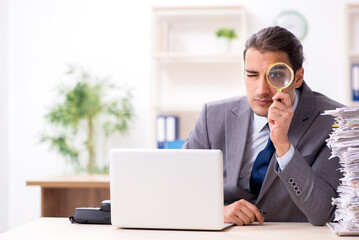 Young male businessman unhappy with excessive work