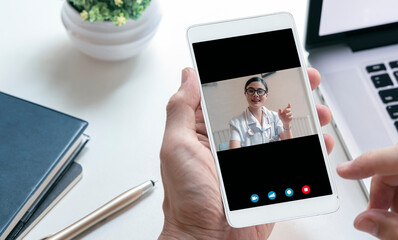 man hand  using smartphone make video call for consultation with his doctor.