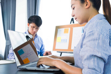 Fototapeta premium Businessmen present to the flipchart during the presentation of the earnings, consult the business performance report, check the report data.