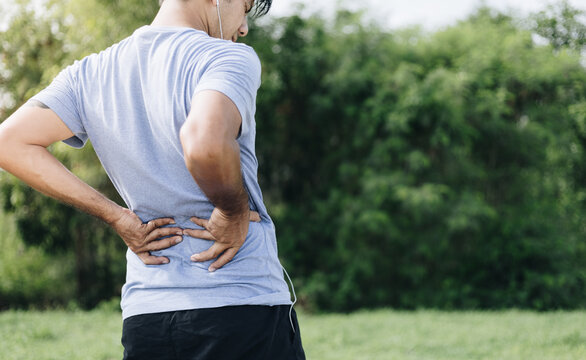 Sport man feeling backache outdoors