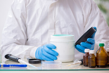 Young male chemist working in medicine lab