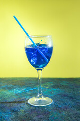 Blue cocktail on yellow blue background.