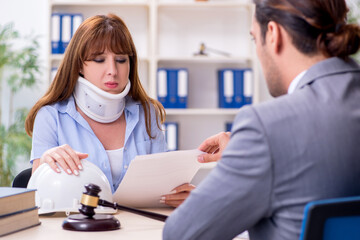 Young injured woman and male lawyer in the courtroom
