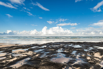 coastline beach sand sea rock sunset
