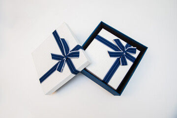 Large white and blue gift box with a smaller box inside on a white background.