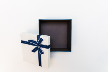 Top view image of Blue and white romantic gift box with ribbon on top.