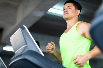 Man running on treadmill  machine at gym sports club. Fitness Healthy lifestye and workout at gym concept.