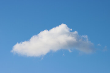 Cloud of steam in the blue sky.