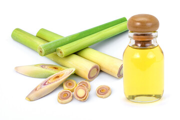 Fresh lemongrass with glass bottle of essential oil extract isolated on white background.