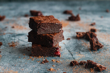 Tasty chocolate brownie with cherry. Pieces of cake on the table