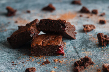 Tasty chocolate brownie with cherry. Pieces of cake on the table