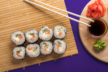 Sushi rolls set served on wooden board
