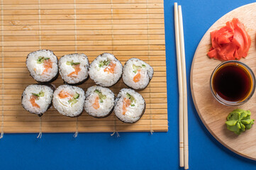 Sushi rolls set served on wooden board