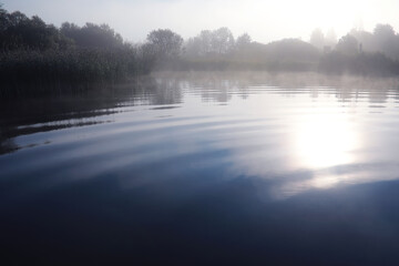 Fog in the lake. Morning nature water white fog.