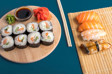 Closeup of fresh sushi and rolls served on wooden board