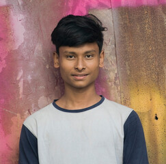 portrait of a teenager boy looking to the camera with mild smile