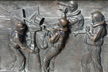 Relief showing soldiers firing anti aircraft gun during Battle of the Atlantic, World War II Memorial in Washington, D.C.