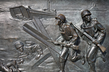 Relief showing beach landing during the Allied invasion of Normandy in 1944, World War II Memorial...