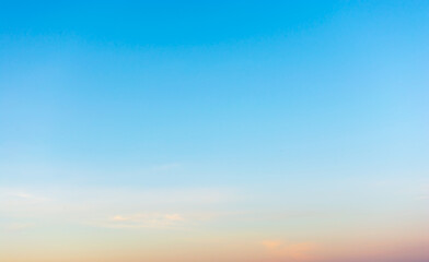 Sky background. Blue sky landscape with colorful sunset clouds lit by evening sunset light - evening sky view.