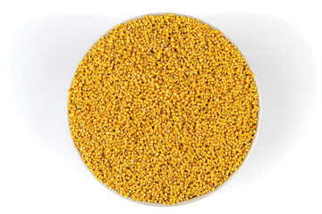 White bowl on a white background with a beautiful slide of millet groats.