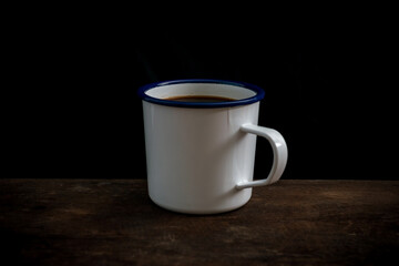 Cup of coffee on old wooden table