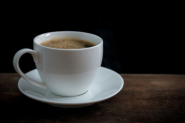 Cup of coffee on old wooden table