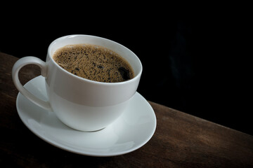 Cup of coffee on old wooden table