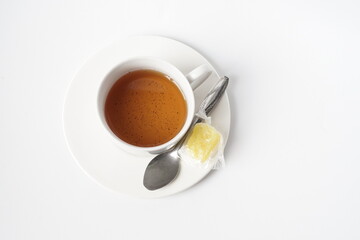 Fresh a cup of tea with rock sugar isolated on white