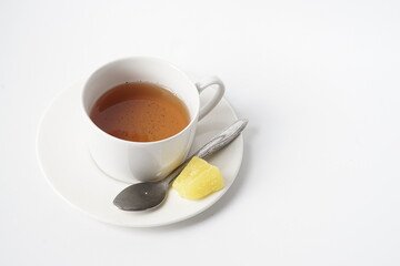 Fresh a cup of tea with rock sugar isolated on white