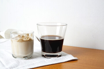 Milk and black coffee on separated glass