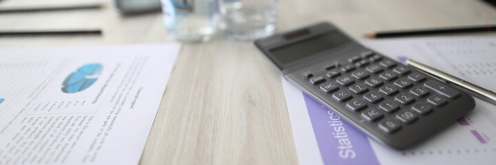 Obraz premium Discussion statistical report, planning are agenda. In meeting room on table are documents with report and current report for future discussion. Nearby lies calculator and there is water in bottle.