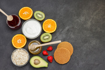 Obraz na płótnie Canvas Oatmeal, avocado berries, fruits, jam, yogurt for Energy Healthy breakfast.