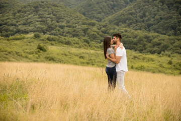 Fototapeta na wymiar Pretty young couple in love outside in spring nature