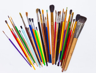 A set of colored artist paint brushes on white background