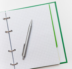 Notepad and pen on a white background