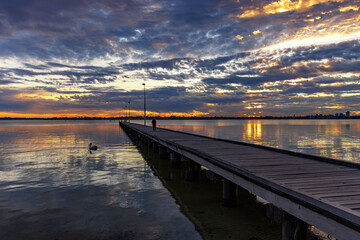 Obraz na płótnie Canvas Colorful sunset sky, Como Jetty Perth, Black Swan Swimming