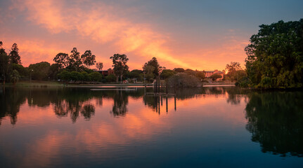 Fototapeta na wymiar Spectacular Lakeside Sunset Panorama with Reflections