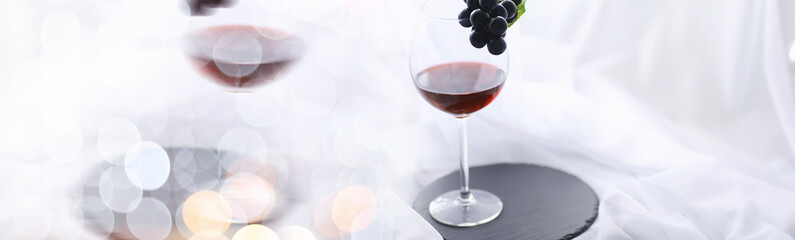 Glass with grape red semi-dry wine. Valentine's day concept background. Gift for the holiday. Sweet sparkling wine.