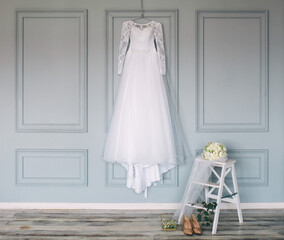 composition - wedding dress on a gray blue wall with decor and accessories