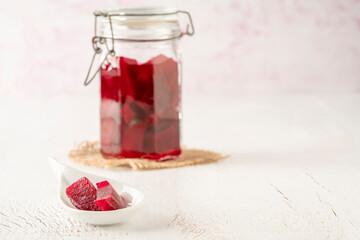 homemade pickled beetroots in jar on table with copy space
