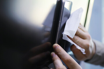 House cleaning concept. Wipe dust off surfaces. Disinfectant treatment of door handles TV electrical. Sanitary treatment at home in quarantine.