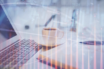 Double exposure of financial chart drawing and desktop with coffee and items on table background. Concept of forex market trading