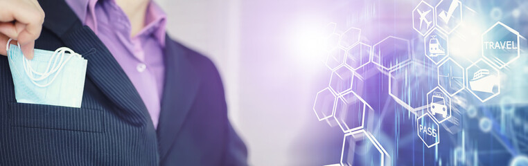 A disposable medical mask sticks out of a pocket instead of a napkin. A man with a disposable mask in a suit and jeans. Individual respiratory protection.