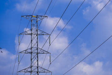 Electrical tower station wiring power with cloudy and blue sky background, High voltage station post